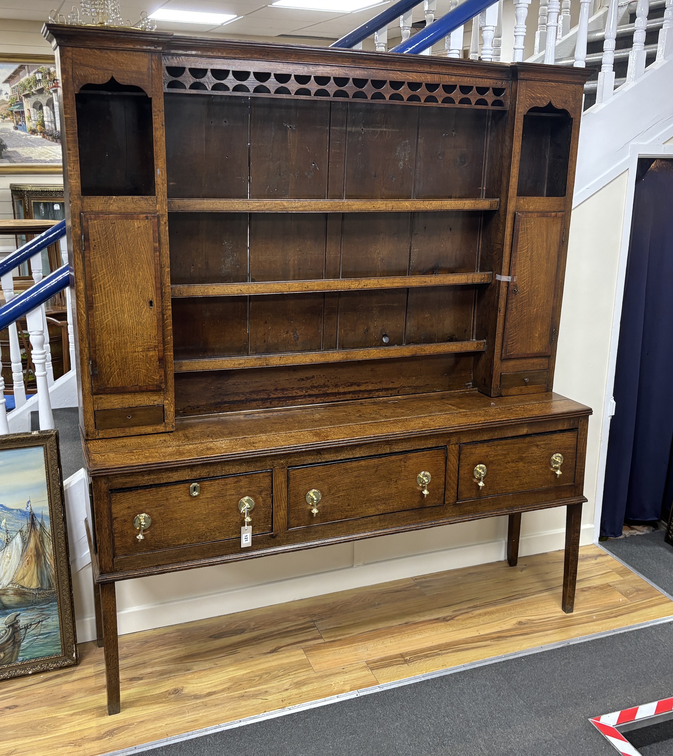 An 18th century oak dresser with boarded rack, width 182cm, depth 45cm, height 211cm